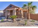 Inviting front porch with stone accents, an iron railing, and a desert landscape at 437 Via Stretto Ave, Henderson, NV 89011