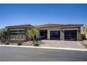 Charming single-story home with a well-maintained landscape and modern glass garage doors at 47 Garibaldi Way, Henderson, NV 89011