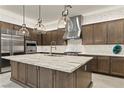 Gourmet kitchen with marble countertops, stainless steel appliances, and stylish pendant lighting at 47 Garibaldi Way, Henderson, NV 89011