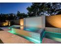 Stunning pool area with elegant tile accents and a unique water feature for outdoor relaxation at 47 Garibaldi Way, Henderson, NV 89011