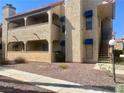 Two-story condo featuring private balconies, exterior stairs, and desert-friendly landscaping at 4704 Obannon Dr # D, Las Vegas, NV 89102