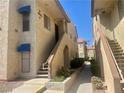 A two-story condo with exterior stairs, desert-friendly landscaping, and visible unit number at 4704 Obannon Dr # D, Las Vegas, NV 89102