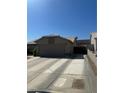 Traditional style house with a long driveway leading to a backyard gate and desert landscaping in front yard at 511 Credence Ave, Henderson, NV 89002