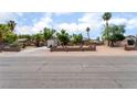 A wide shot of the property showing the front exterior, desert landscaping, and a two-car garage at 5312 Manuel Dr, Las Vegas, NV 89149