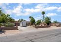 A wide shot of the property showing the front exterior, desert landscaping, and a two-car garage at 5312 Manuel Dr, Las Vegas, NV 89149