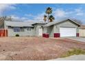 Charming single-story home with a well-maintained front yard and attached two-car garage at 5620 Pinecone Pl, Las Vegas, NV 89108