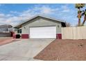 A single-story home features an attached two-car garage and a well-maintained front yard at 5620 Pinecone Pl, Las Vegas, NV 89108