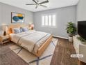Modern bedroom with natural light, ceiling fan, and stylish decor at 6053 Lambert Bridge Ave, Las Vegas, NV 89139