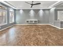 Spacious room with tile flooring, modern ceiling fan, recessed lighting, and a built in wall unit at 6053 Lambert Bridge Ave, Las Vegas, NV 89139