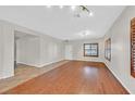Spacious living room featuring light walls, hardwood floors, and natural light at 65 Pangloss St, Henderson, NV 89002