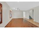 Bright living room with hardwood floors, light walls, and shuttered windows at 65 Pangloss St, Henderson, NV 89002