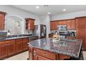 Bright kitchen features stainless steel appliances, granite countertops, and a convenient center island at 7641 Lani Dawn St, Las Vegas, NV 89149