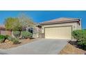 Attractive single-story home with a well-kept lawn, desert landscaping, and a spacious two-car garage at 7760 Pine Warbler Way, North Las Vegas, NV 89084