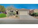 Charming single-story home featuring a well-maintained front yard, desert landscaping, and a two-car garage at 7760 Pine Warbler Way, North Las Vegas, NV 89084