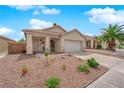 Inviting single-story home featuring a two-car garage, covered porch, and drought-tolerant landscaping at 8009 Tailwind Ave, Las Vegas, NV 89131