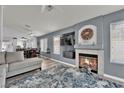 Cozy living room with fireplace, recessed lighting, and adjacent dining area for easy entertaining at 8009 Tailwind Ave, Las Vegas, NV 89131