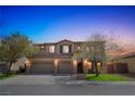 Elegant two-story home boasts a three-car garage, manicured lawn, mature trees, and a charming stone and stucco facade at 8537 Eureka Heights Ct, Las Vegas, NV 89178