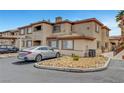 View of the multi-Gathering home showcasing covered parking and desert landscaping at 8725 W Flamingo Rd # 240, Las Vegas, NV 89147