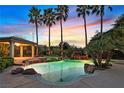 Luxurious swimming pool and spa surrounded by lush landscaping and a relaxing covered patio area at 9008 Sawhill Pond St, Las Vegas, NV 89131