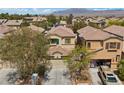 An aerial view of a neighborhood showcasing a well-maintained home and surrounding landscaping at 9060 Watermelon Seed Ave, Las Vegas, NV 89143