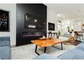 A modern living room features a sleek fireplace and stylish decor, creating a comfortable atmosphere at 11244 Playa Caribe Ave, Las Vegas, NV 89138
