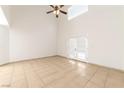 Bright living room featuring high ceilings, tile floors, and glass patio doors at 121 Golf Course St, Las Vegas, NV 89145