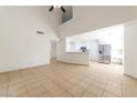 Open concept living area with tile floors, stainless steel refrigerator, and white cabinets at 121 Golf Course St, Las Vegas, NV 89145