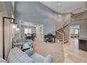 Elegant living room featuring a grand staircase, high ceilings, and comfortable seating at 193 Glenbrook Estates Dr, Las Vegas, NV 89183