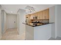 Modern kitchen with stainless steel appliances and granite countertops, open to the dining area at 210 E Flamingo Rd # 105, Las Vegas, NV 89169