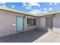 Inviting front entrance with a turquoise door, gray pavers, and neutral stucco walls at 2205 Sombrero Dr, Las Vegas, NV 89169