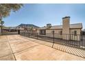 Large concrete backyard with perimeter fencing, featuring mountain views and a desert landscape at 239 Eugene Way, Henderson, NV 89015