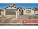 Single-story home with two-car garage, low maintenance desert landscaping, and inviting facade at 239 Eugene Way, Henderson, NV 89015