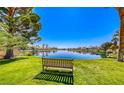 Beautiful lake view with bench and lush greenery, perfect for relaxing outdoors at 3125 N Buffalo Dr # 1133, Las Vegas, NV 89128