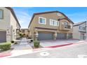 View of a two story townhome with a private balcony and attached garages at 4625 Ridgeley Ave # 102, North Las Vegas, NV 89084