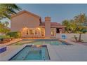 Stunning backyard showcasing a sparkling pool and spa with a covered patio, perfect for outdoor relaxation and entertainment at 4651 Munich Ct, Las Vegas, NV 89147