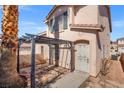 Enclosed backyard with stone tile patio and pergola, perfect for outdoor entertaining at 51 Belle Point Ave, Las Vegas, NV 89123