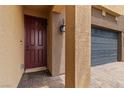 A close-up of a home's front door and column with brick-style flooring at 5317 Golden Melody Ln, North Las Vegas, NV 89081