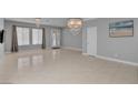 Spacious living room featuring tile flooring, chandelier, and natural light at 6236 Mount Palomar Ave, Las Vegas, NV 89139