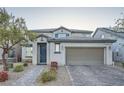 Inviting two-story home with a brick driveway, a neutral color palette, and well-maintained landscaping at 6445 N Alpine Ridge Way, Las Vegas, NV 89149