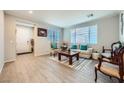 Bright living room featuring neutral walls, tiled floors, and stylish furniture arrangement at 6445 N Alpine Ridge Way, Las Vegas, NV 89149