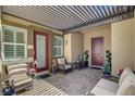 Relaxing covered patio with comfortable seating, ideal for outdoor entertaining at 7095 Falabella Ridge Ave, Las Vegas, NV 89131
