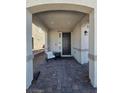 Inviting front porch with a seating area and stylish brick flooring at 7114 Superstar St, North Las Vegas, NV 89084