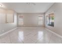 Bright living room featuring tile floors, neutral colors, and large windows at 7116 Wonderberry St, Las Vegas, NV 89131