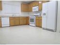 Spacious kitchen featuring white appliances and light-toned cabinets at 7173 Las Colinas Ave, Las Vegas, NV 89179