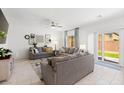 Bright living room featuring neutral paint, tile floors, and sliding glass doors to the backyard at 7714 Duran Harbor Ln, North Las Vegas, NV 89084