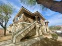 Charming home exterior featuring a staircase leading to the main floor on a sunny day at 833 Aspen Peak Loop # 1021, Henderson, NV 89011