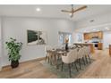 Inviting dining area featuring sleek table, modern chairs, and a view of the kitchen, ideal for Gathering meals at 8537 Glenmount Dr, Las Vegas, NV 89134