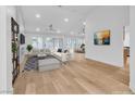Open-concept living room with fireplace, modern seating, and seamless flow to the dining area and kitchen at 8537 Glenmount Dr, Las Vegas, NV 89134