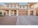 Stunning two-story home with a three-car garage, columns, and elegant front yard landscaping at 8543 Alpine Vineyards Ct, Las Vegas, NV 89139
