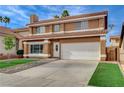 Inviting two-story home showcasing a tile roof and lush green lawn at 8636 Caribbean Ct, Las Vegas, NV 89117